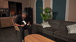 Busty stepmom plays with her stepson’s cock while her husband plays with his console