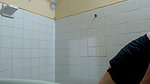 This girl is undressing to take a bath
