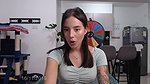 Sensual tattooed girl with an innocent appearance moves around