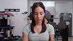 Sensual tattooed girl with an innocent appearance moves around