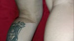 Tattooed Latin woman, black heels plays modeling