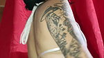 Tattooed Latin woman, black heels plays modeling