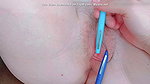 with pens in her pussy on each lip pushing it in