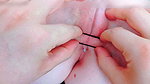 with tweezers destroying her pink pussy opening it