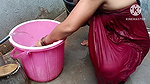 Indian housewife bathing with