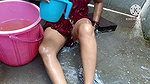 Indian housewife bathing with
