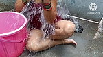 Indian housewife bathing with