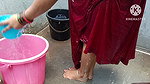 Indian housewife bathing with