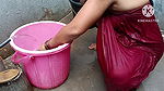 Indian housewife bathing with