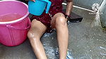 Indian housewife bathing with