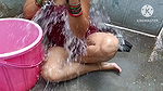 Indian housewife bathing with