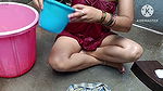 Indian housewife bathing with