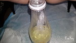 a kay Peeing in a bottle
