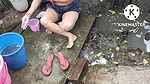 Indian house wife bathing outside