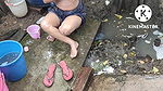 Indian house wife bathing outside