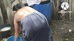 Indian house wife bathing outside
