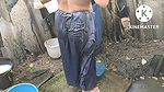 Indian house wife bathing outside