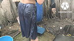 Indian house wife bathing outside