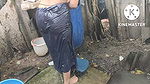 Indian house wife bathing outside