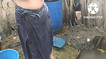 Indian house wife bathing outside