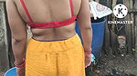 Indian house wife bathing outside