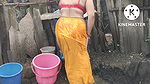 Indian house wife bathing outside