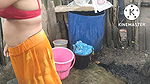 Indian house wife bathing outside