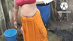 Indian house wife bathing outside