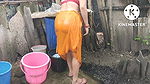 Indian house wife bathing outside