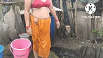 Indian house wife bathing outside