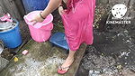 Indian house wife bathing outside