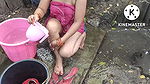 Indian house wife bathing outside