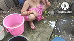 Indian house wife bathing outside