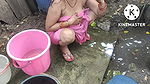 Indian house wife bathing outside