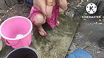 Indian house wife bathing outside