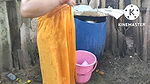 Indian house wife bathing outside