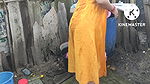 Indian house wife bathing outside