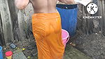 Indian house wife bathing outside