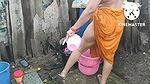 Indian house wife bathing outside