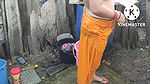 Indian house wife bathing outside