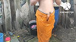 Indian house wife bathing outside