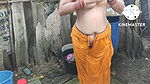 Indian house wife bathing outside