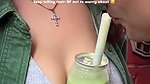 Sexy girl boobs enjoyed by boyfriend drinking juice
