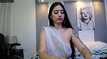 Hot beauty in see through white saree showing her boobs