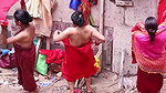 Multiple women wearing clothes after bath at ghat