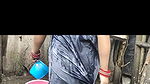 Indian house wife bathing outside