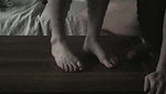A guy gets excited when a girl tramples his dick with her slender legs